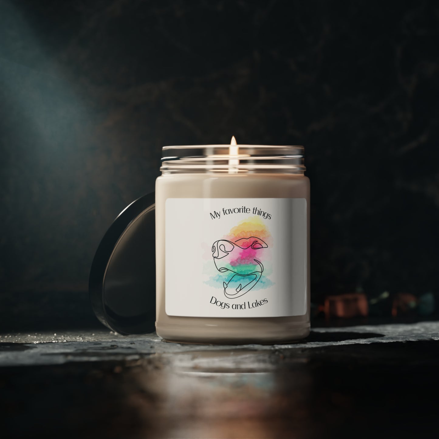 My Favorite Things ... Dogs and Lakes Scented Candle, 9oz, featuring a line drawing of a cute face face with multi-color watercolor background