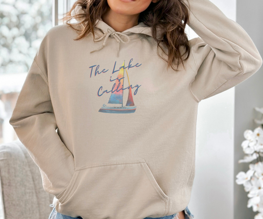 The Lake is Calling Colorful Sailboat Unisex Hoodie, lettering diagonally positioned over a colorful sailboat