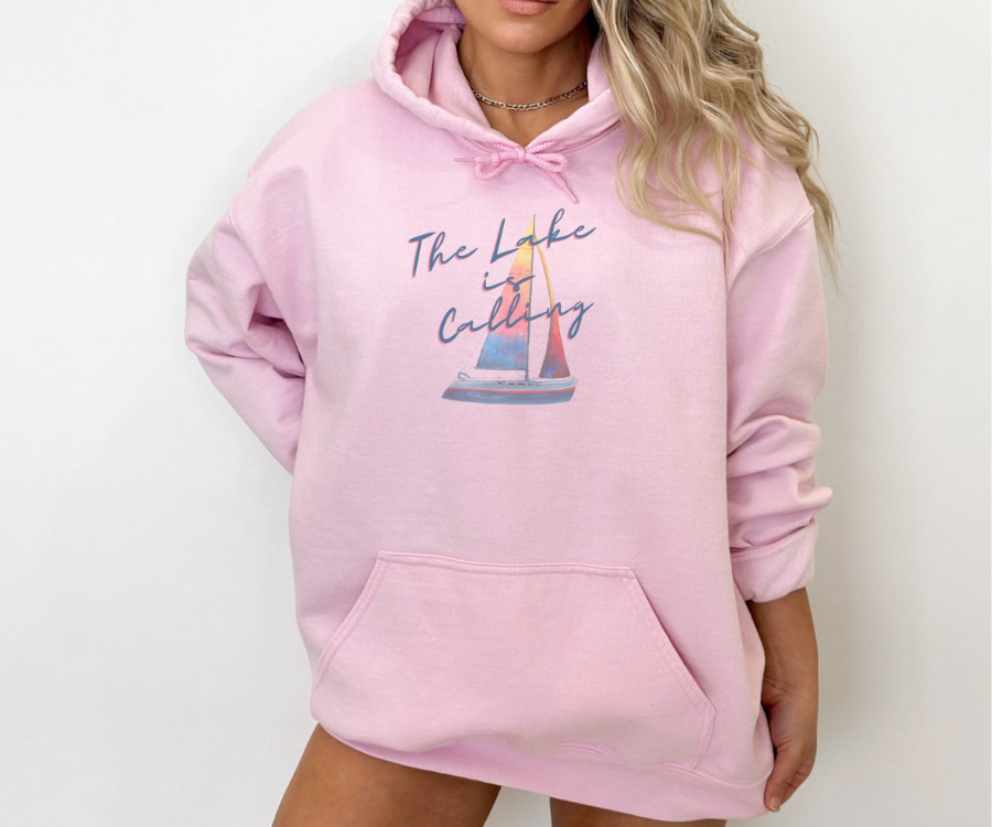 The Lake is Calling Colorful Sailboat Unisex Hoodie, lettering diagonally positioned over a colorful sailboat