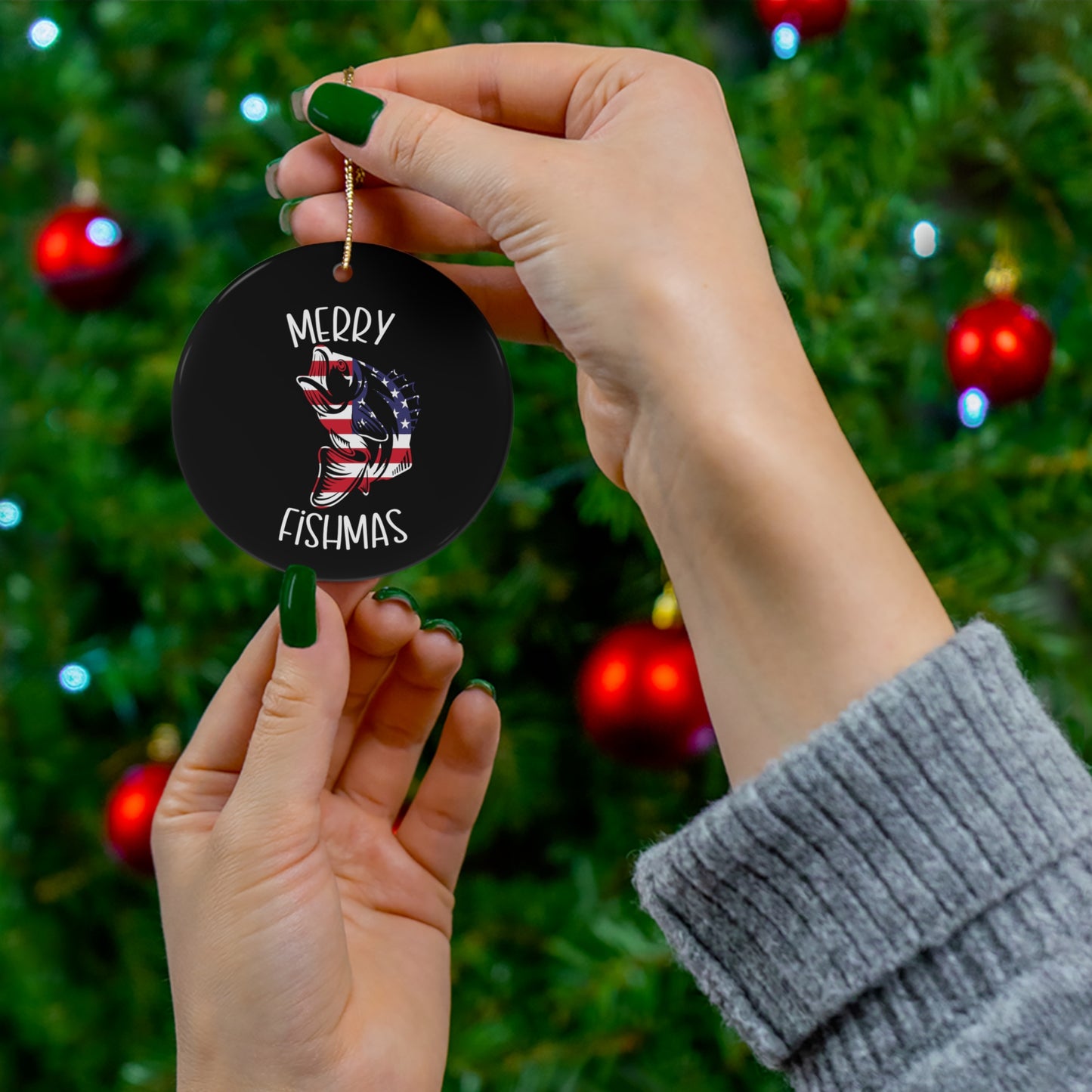 Merry Fishmas Ceramic Ornament, circle shaped tree ornament with a red white and blue bass, white lettering on a black colored background