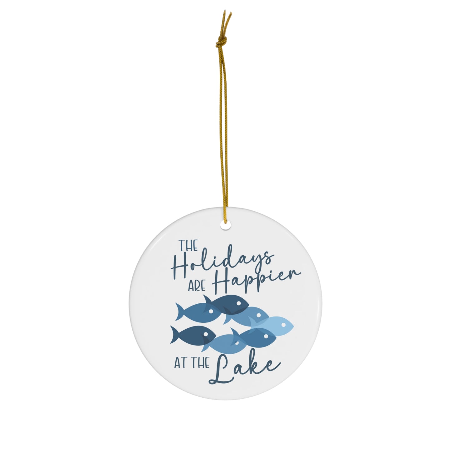 The Holidays are Happier at the Lake Ceramic Ornament, circle shaped tree ornament featuring school of fish and lettering in blue against a white backdrop