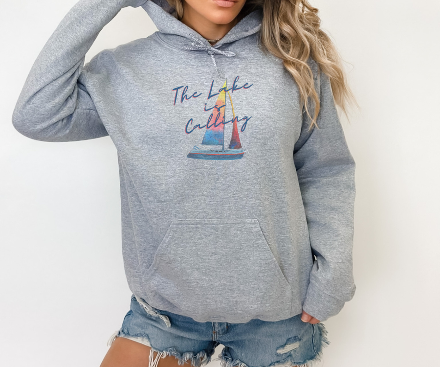 The Lake is Calling Colorful Sailboat Unisex Hoodie, lettering diagonally positioned over a colorful sailboat