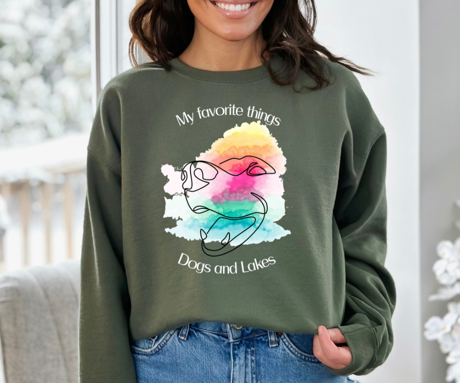 My Favorite Things ... Dogs and Lakes Unisex Sweatshirt, featuring a line drawing of a cute dog face on a multi-color watercolor back drop.