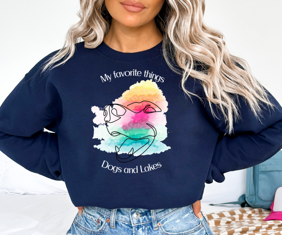 My Favorite Things ... Dogs and Lakes Unisex Sweatshirt, featuring a line drawing of a cute dog face on a multi-color watercolor back drop.