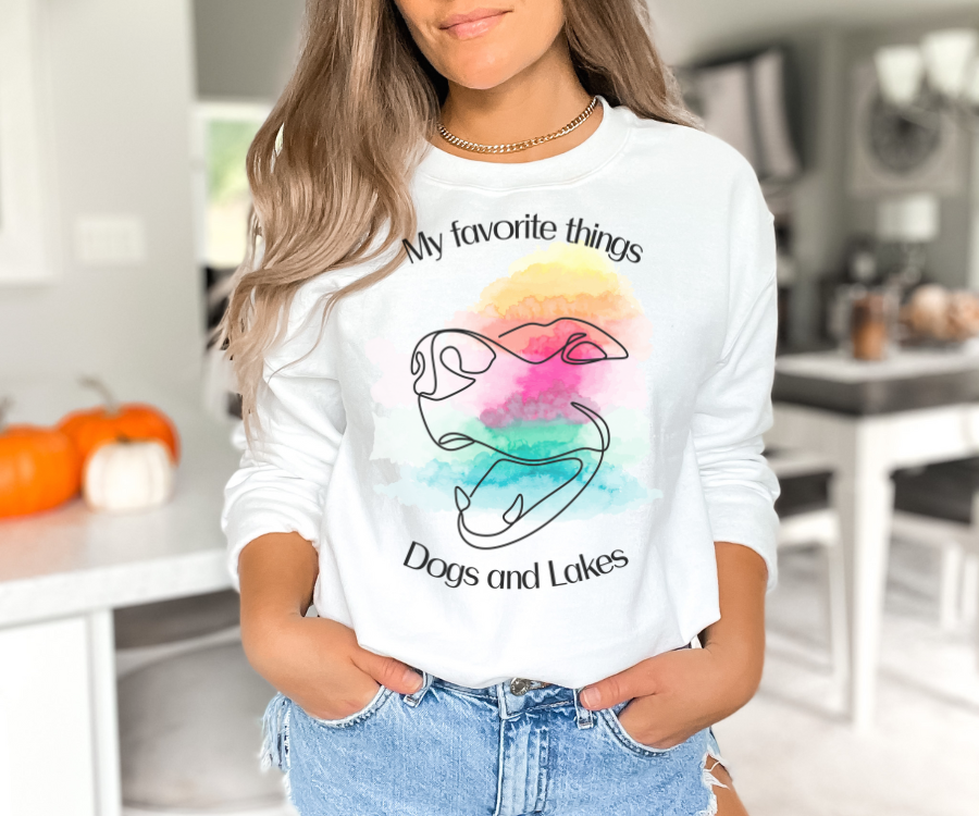 My Favorite Things ... Dogs and Lakes Unisex Sweatshirt, featuring a line drawing of a cute dog face on a multi-color watercolor back drop.