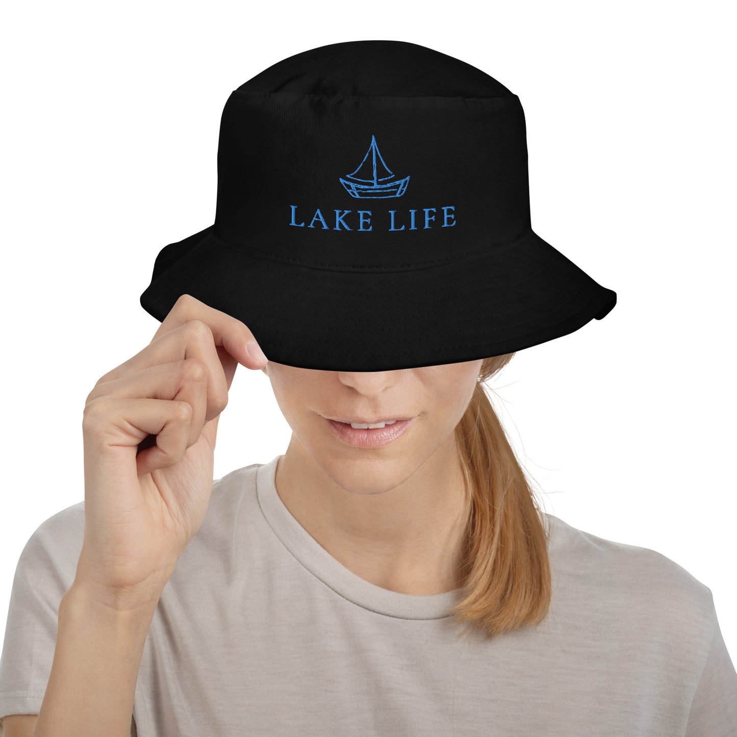 Lake Life Sailboat Bucket Hat, featuring a simple sailboat drawing in blue accompanied by the words Lake Life below the design