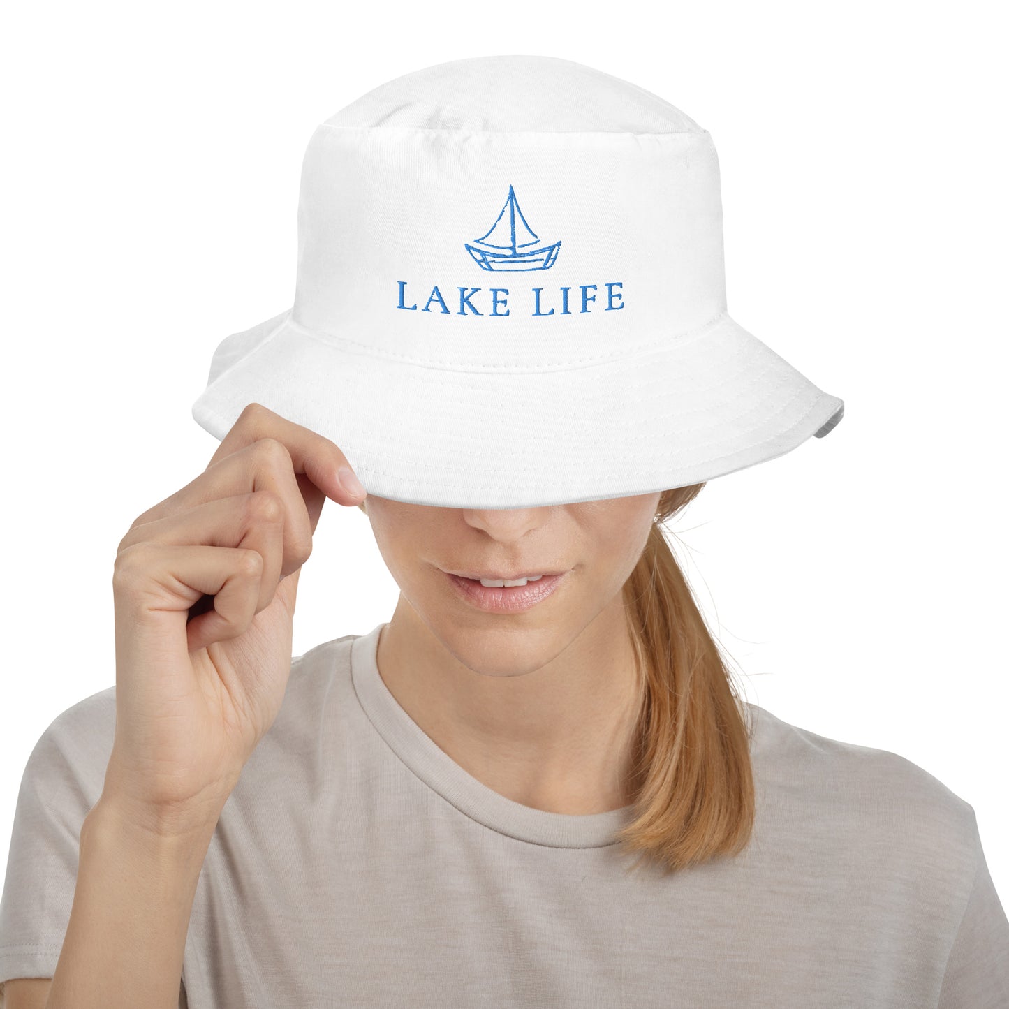 Lake Life Sailboat Bucket Hat, featuring a simple sailboat drawing in blue accompanied by the words Lake Life below the design