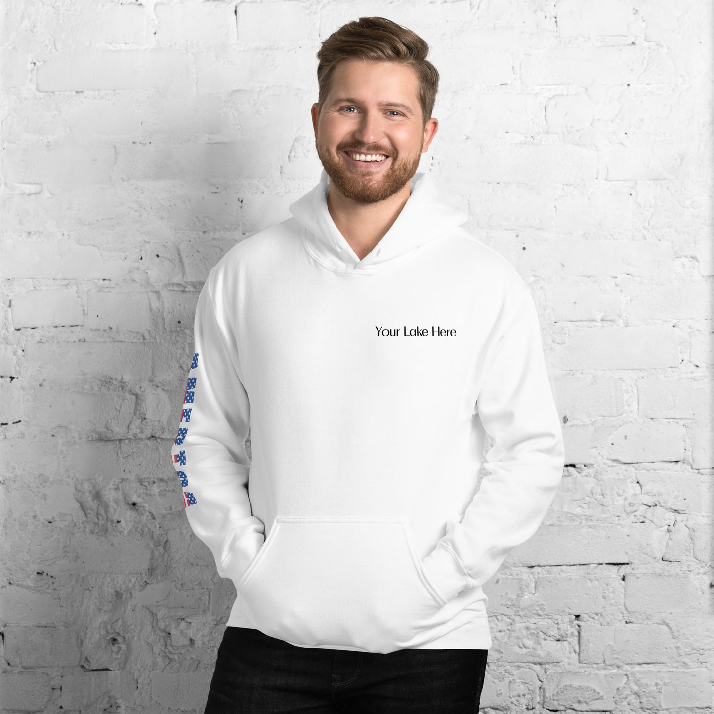 Customizable Reeling in Freedom: Hooked on Red, White, and Blue Personalized Unisex Hoodie featuring the name of your lake on the front left chest, a large patriotic fish design covering the back and America down the right sleeve